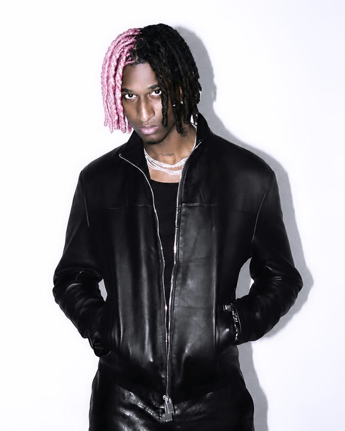 Kill Cupid in a black leather jacket with pink-and-black hair