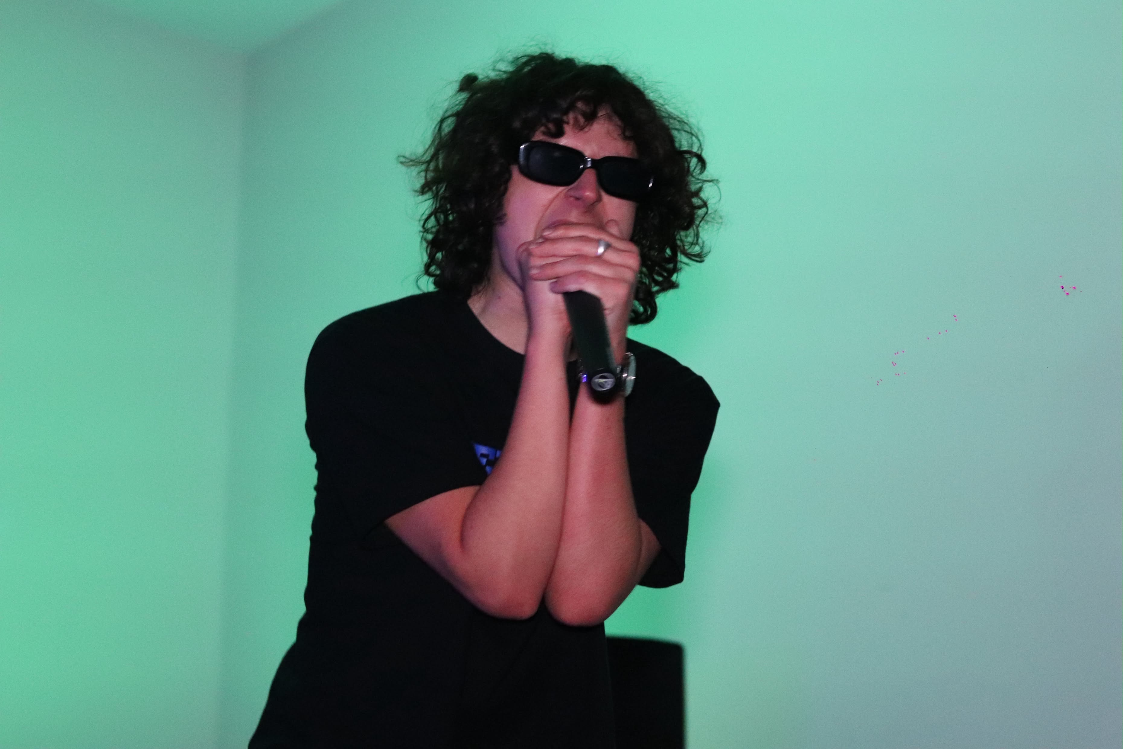Tennants performing with sunglasses under green lighting
